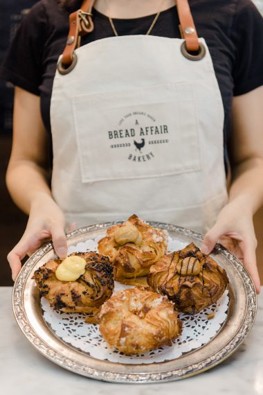 Four Kouign Amann Pastries on a platter at A Bread Affair