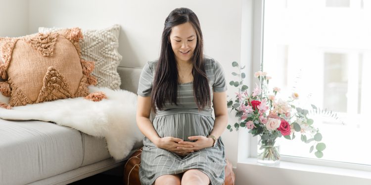 Pregnant Blogger wearingg Ripe Maternity Crop Top Nursing Dress in Olive and White