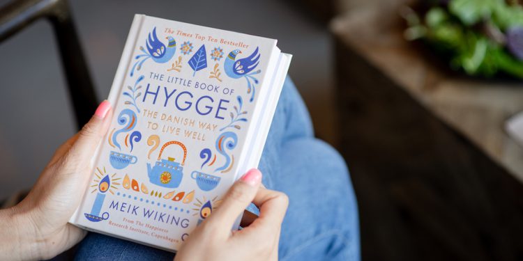 Holding Hardcover Book in Hands The Little Book of Hygge